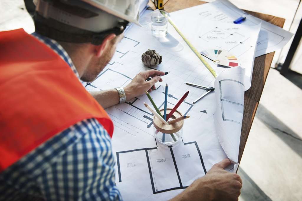 Male construction worker drawing a site plan