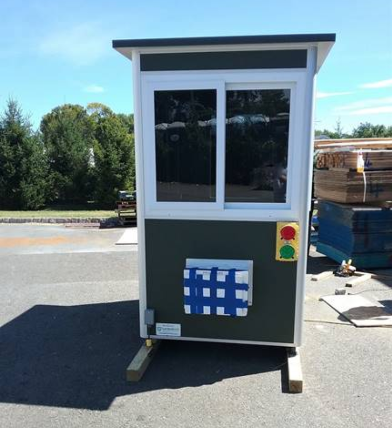 A guard booth with a red and green traffic light