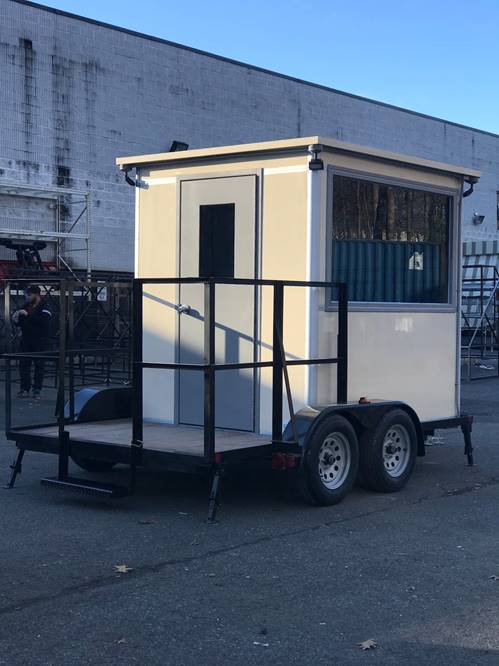 Beige bullet resistant trailer booth manufactrered by Guardian Booth