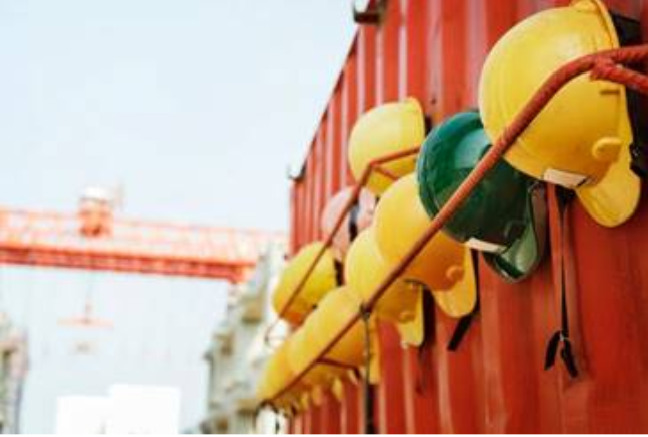 Yellow construction hats hanging on a wall