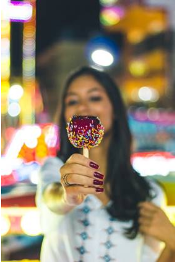 Girl holding colorful toffy