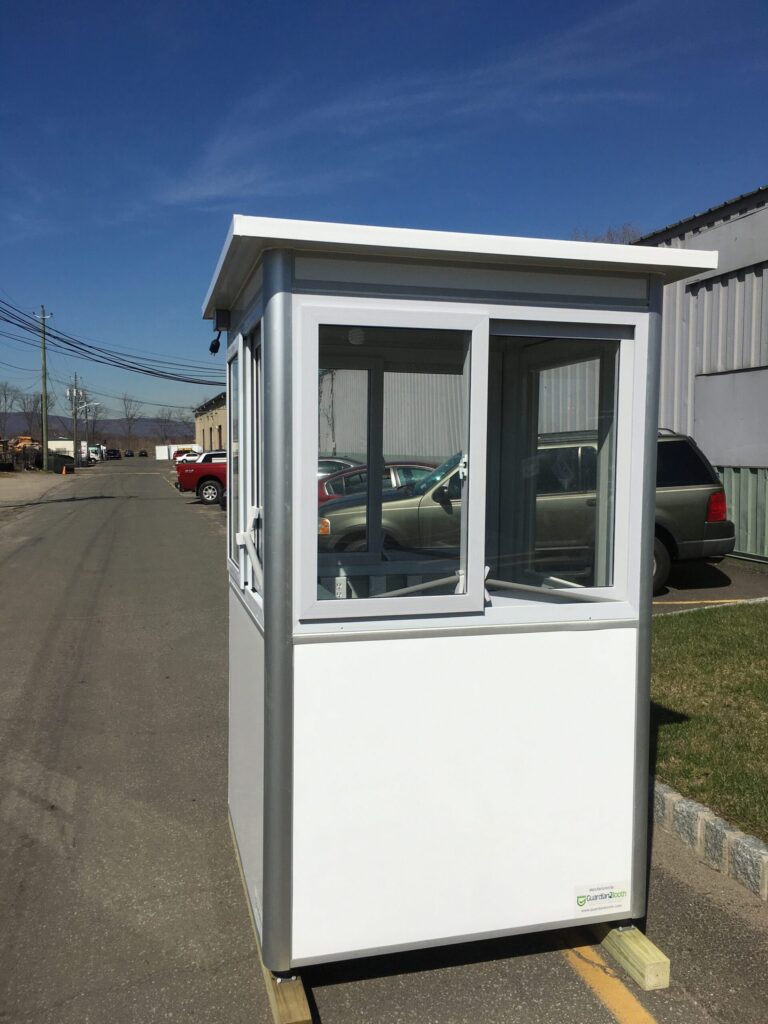 4x4 Security Guard Booth in Portland, OR on Construction Site with Custom Exterior Color, Sliding Windows, and Swing Door