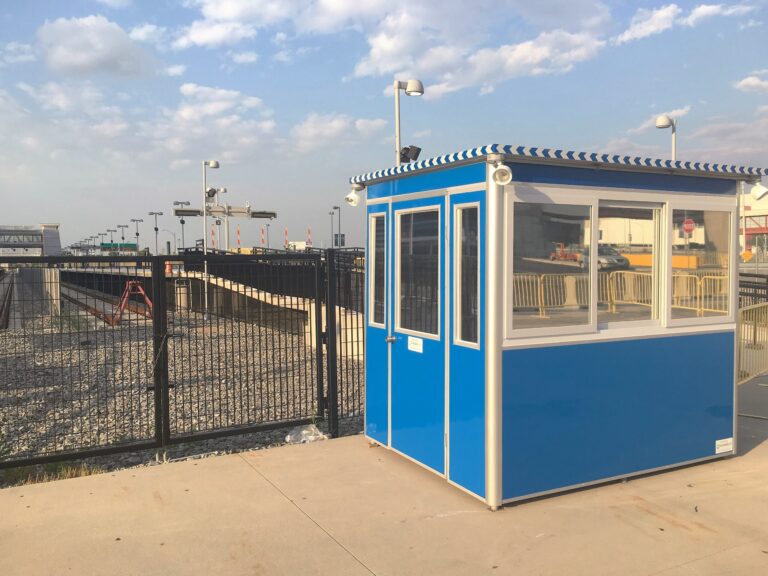 6x8 Security Guard Booth in Rutherford, NJ outside the Stadium with Swing Door, Outside Spotlights, and Perimiter Security Fencing