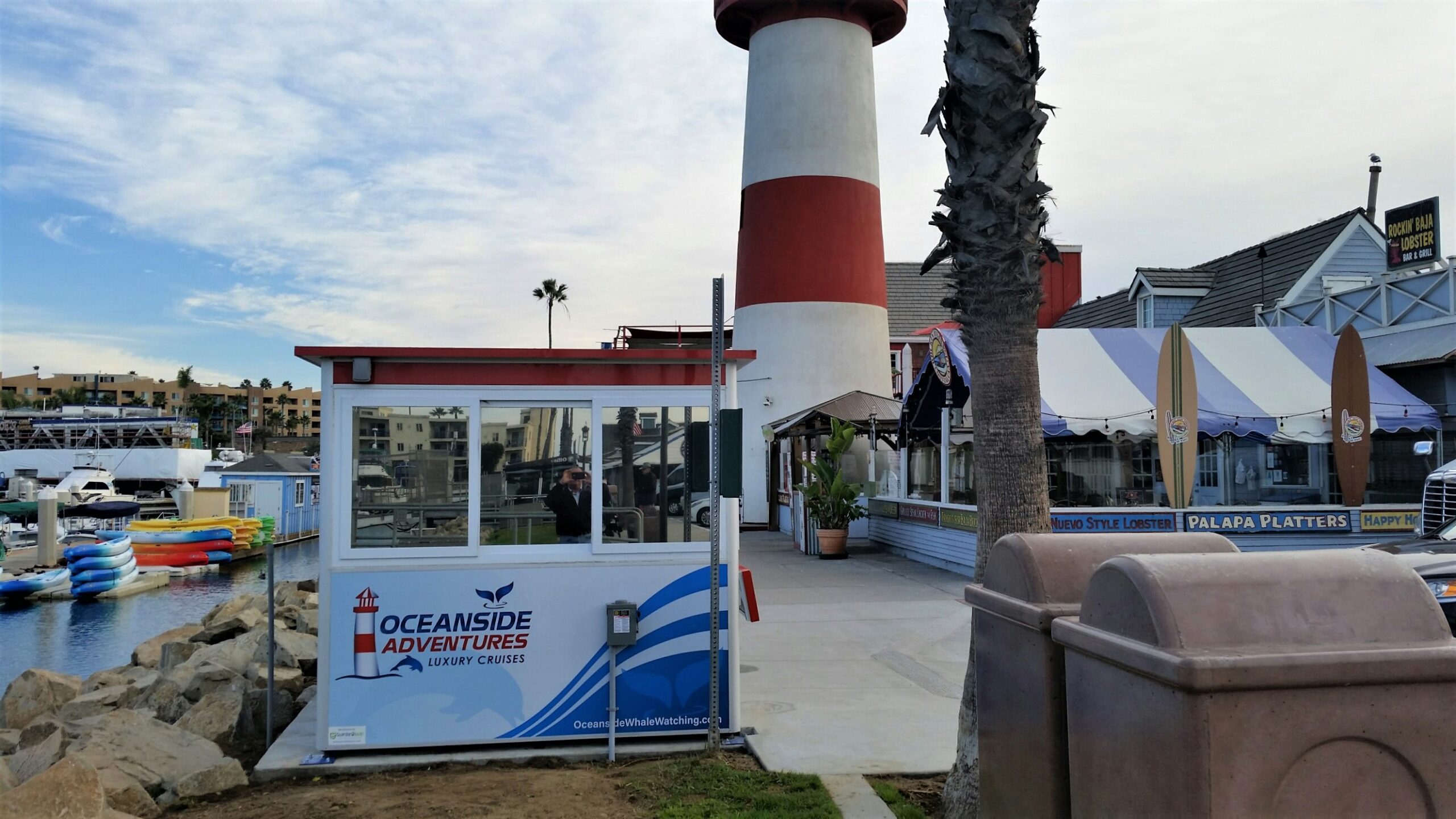 8x10 Ticket Booth in Oceanside,CA outside Harbor with Custom Graphics,Tinted Windows, Anchoring Brackets, Electric Disconnect Switch