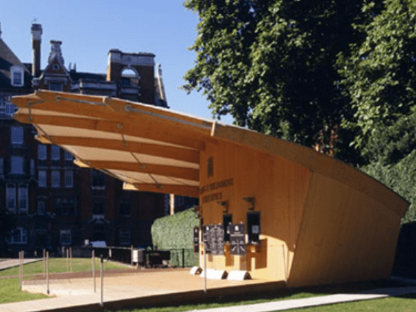 A large wooden ticket booth with large rain awning