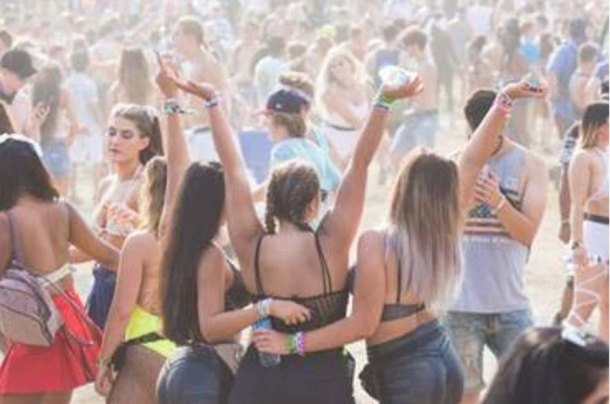 Girls holding hands at a music festival