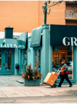 A delivery person going into a store