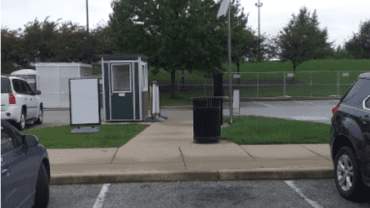 Parking lot with green parking booth in distance