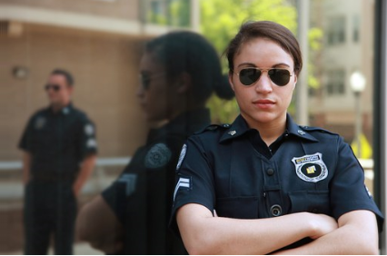 A female guard with arms folded.