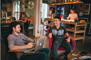 People working in a room decorated like a coffee shop