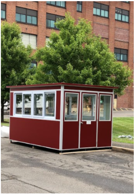 A school with a red security booth