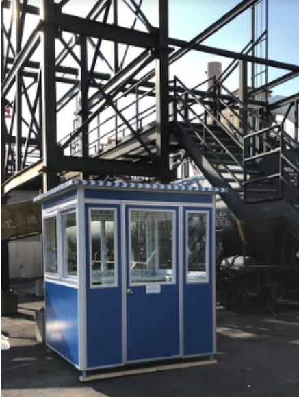 Blue guard booth in front of construction building