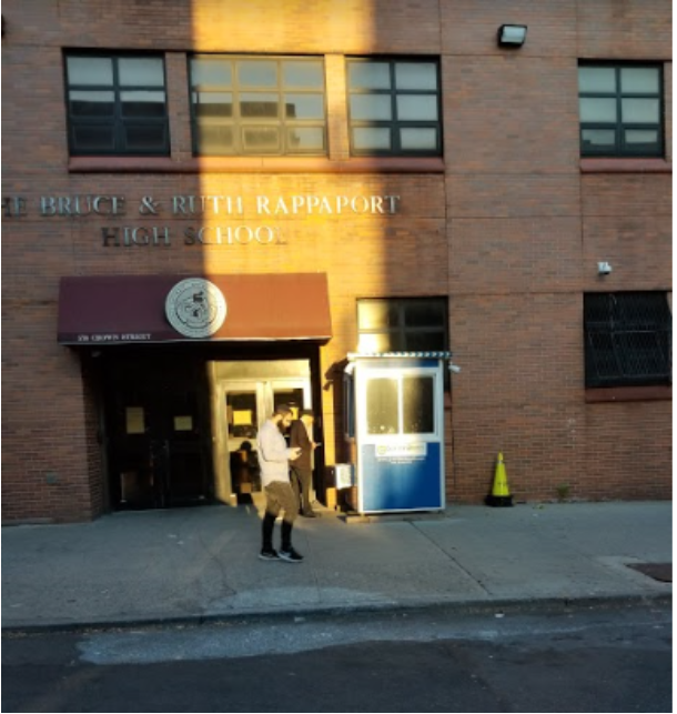 High school entrance with a blue security booth beside it