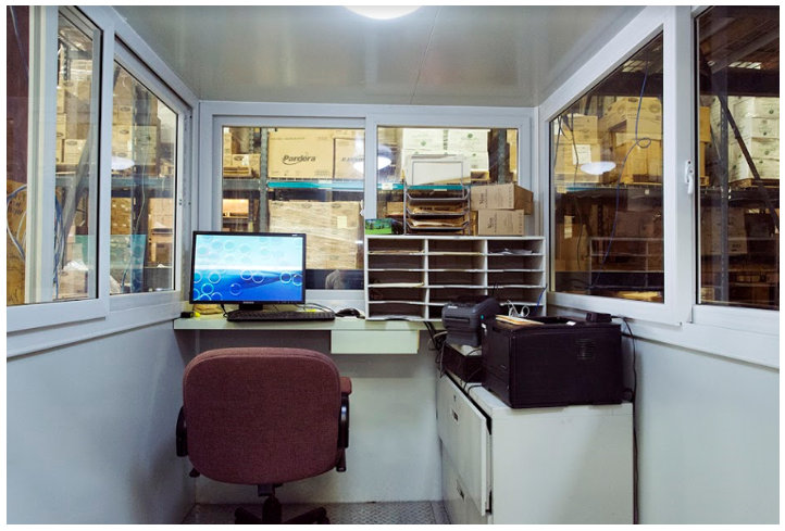 Inside an prefab office she shed for sale with chair and computer