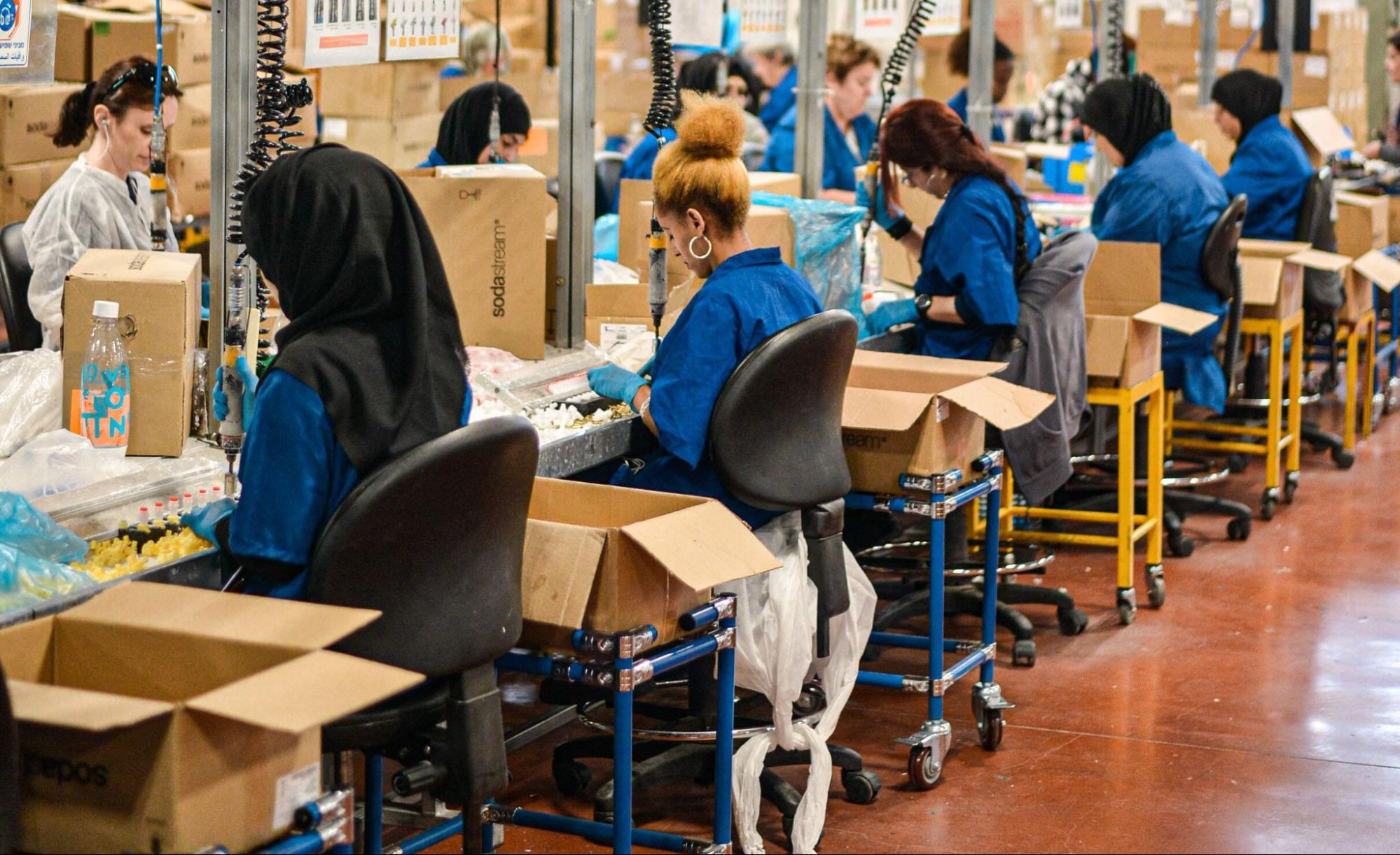 row of women working in manufacturing facility