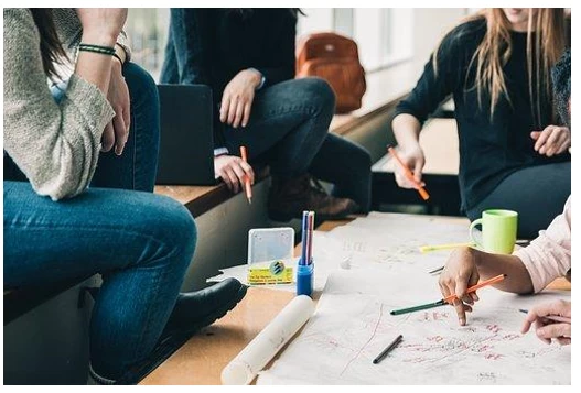 College students having team meeting