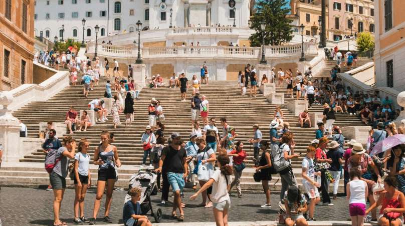 Tourists at destination where tourism information kiosks enhance tourist experience